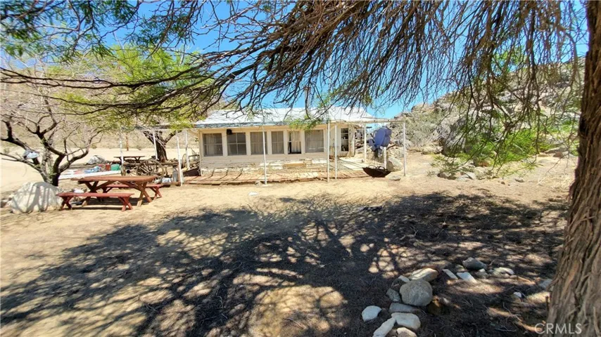 Looking at the front of the rec. cabin. Rock outcrop on the east or right side of the pic.