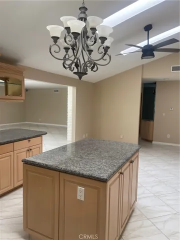 Island has electrical outlets & storage for trash