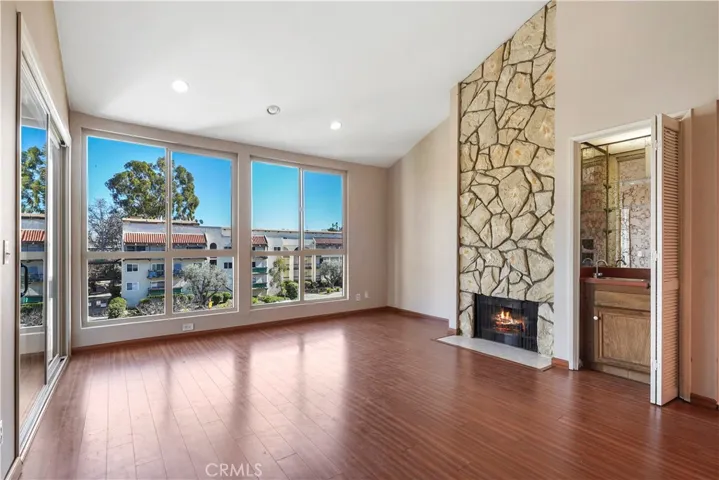 Living room with high ceilings, rock fire place, floor to ceiling windows