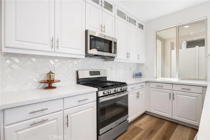 Custom beveled herringbone 
 backsplash and custom display cabinetry