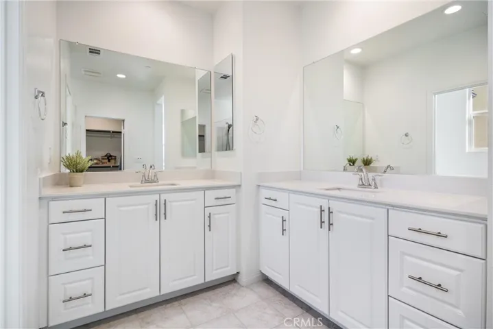 Primary Suite ensuite bathroom has dual vanities and storage