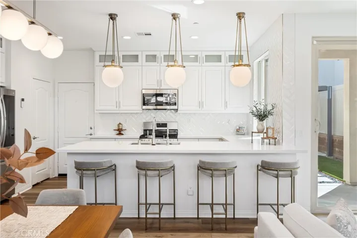 Gorgeous chef's kitchen with quartz breakfast bar