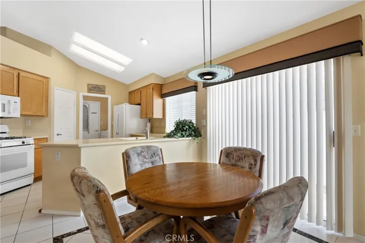 Casual dining area in the family room with a slider to a side patio.