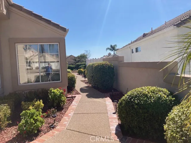 Side walkway to backyard.  There is vinyl fencing on this side of the home.