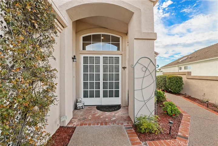 Your private entry courtyard features lovely textured concrete with brick accents.  Double screen doors for cool breezes.