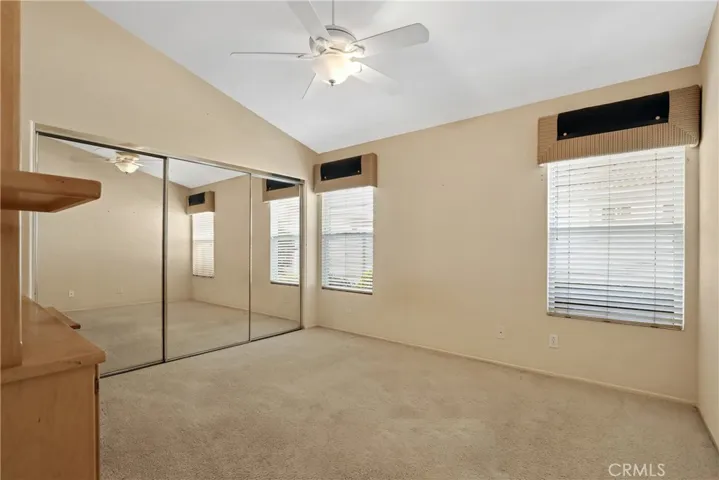 Oversized second bedroom with a wall of closets.