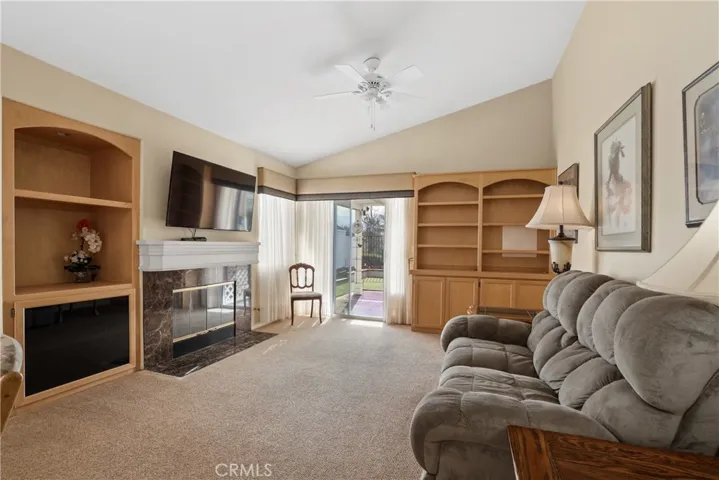 Family room with a fireplace and built-in cabinet.