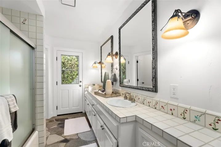 Hallway Bathroom with Dual Sinks, Shower & Tub