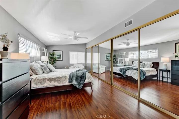 Upstairs Extra Large Bedroom with Retreat Area and Wall-to-Wall Mirrored Closets. Door in Closet Opens to the Attic with Tons of Storage Space.
