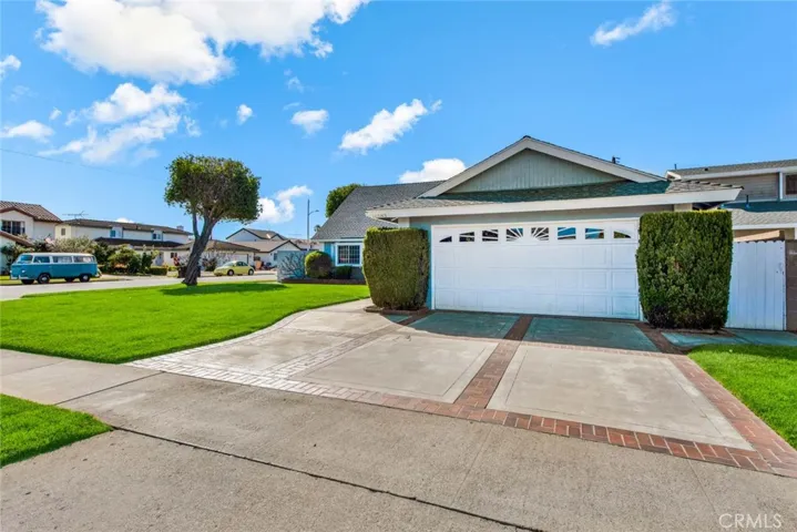 Beautiful Curb Appeal with Large Front Lawn, Raised Brick Planter, Brick Accented Driveway and Walkway
