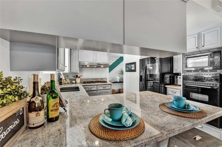 Remodeled and Upgraded with Granite Countertops, Stainless Sinks, a Garden Window, 5-Burner Gas Cooktop, Vent/Hood, Oven, Microwave, Dishwasher, Breakfast Bar, and Repainted Chic Gray Cabinetry