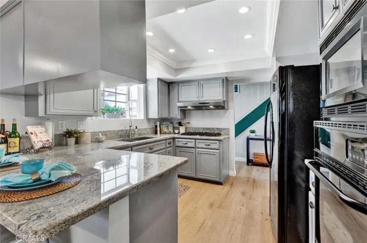 Kitchen has Garden Window and Tray Ceiling with Recessed Lighting