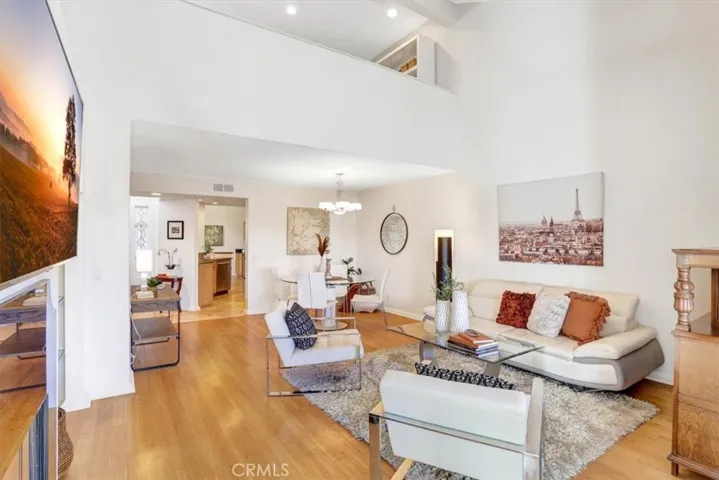 The dining & living rooms flow openly together for ease of entertaining. Above is the open loft overlooking the rooms below.