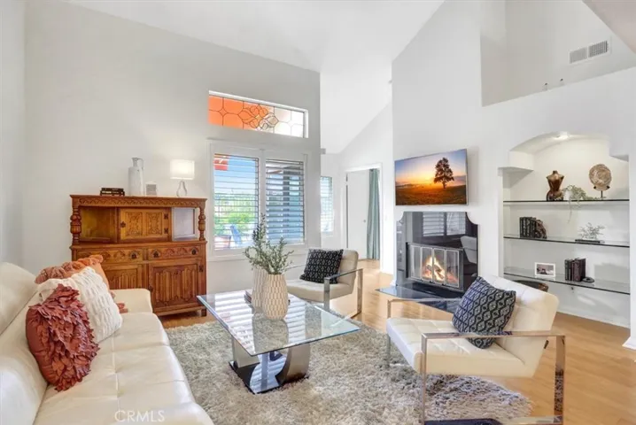 The living room is anchored by a gas fireplace, offering a cozy focal point.
