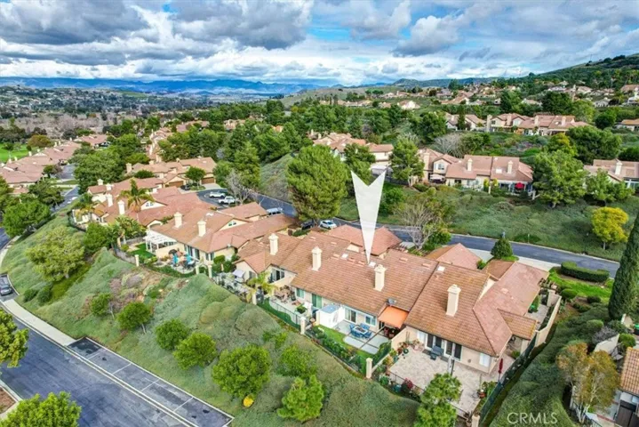 Aerial view of the back of the residence and the scenic topography that surrounds the community.
