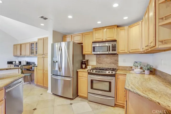 Beautifully appointed kitchen will delight the chef with warm granite counters & cabinetry, stainless appliances, and plenty of storage & work space.