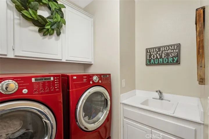 Upstairs laundry room with utility sink.