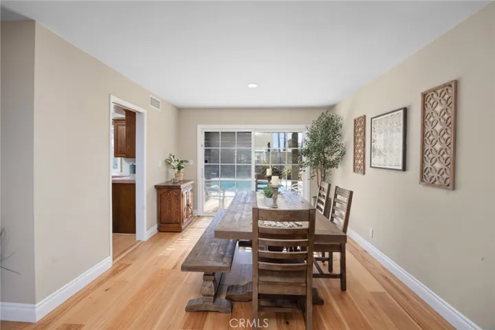 The dining room doors open onto the a delightful and tranquil backyard setting!
