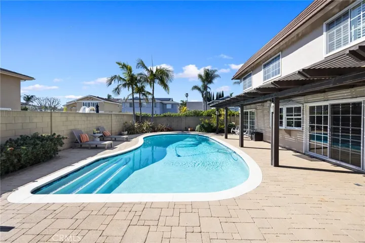 Relaxing backyard spotlighting a shimmering pool and featuring a recently re-plastered/refurbished pool by Alan Smith Pools~