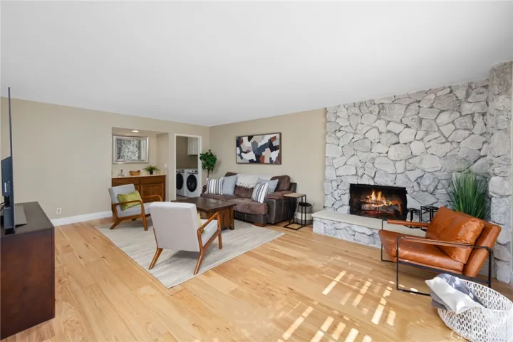 Great Room features a captivating natural rock fireplace & hearth and built-in wet bar!