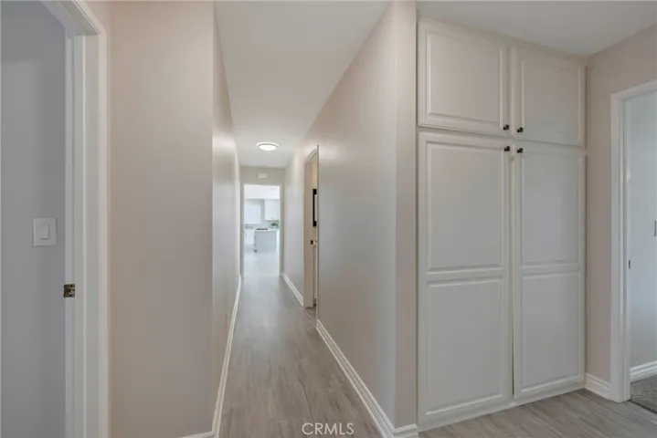 Hall to primary bedroom with abundant linen storage
