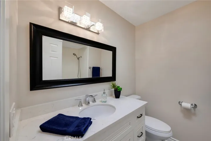 Full hallway bathroom with white shaker cabinets