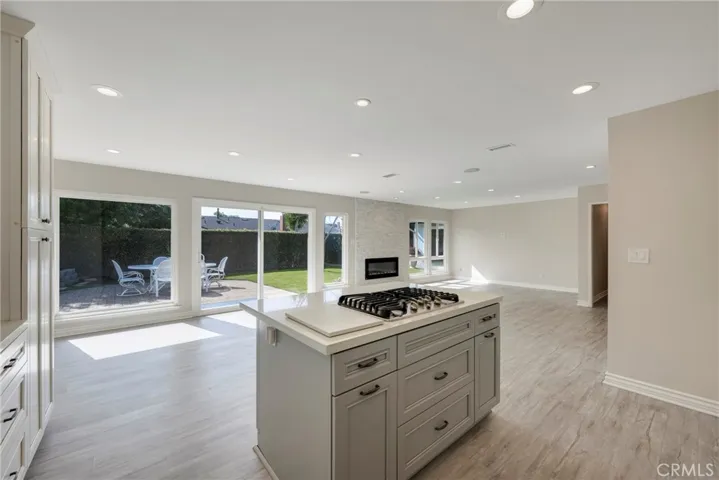 Grey shaker Island with convenient electric outlets and pot drawers