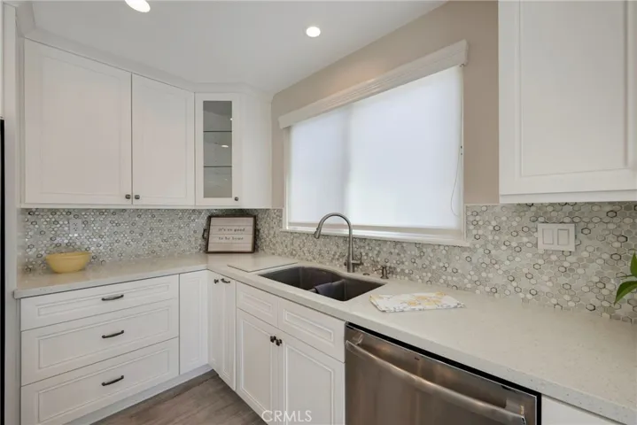 White shaker cabinets and stainless dishwasher