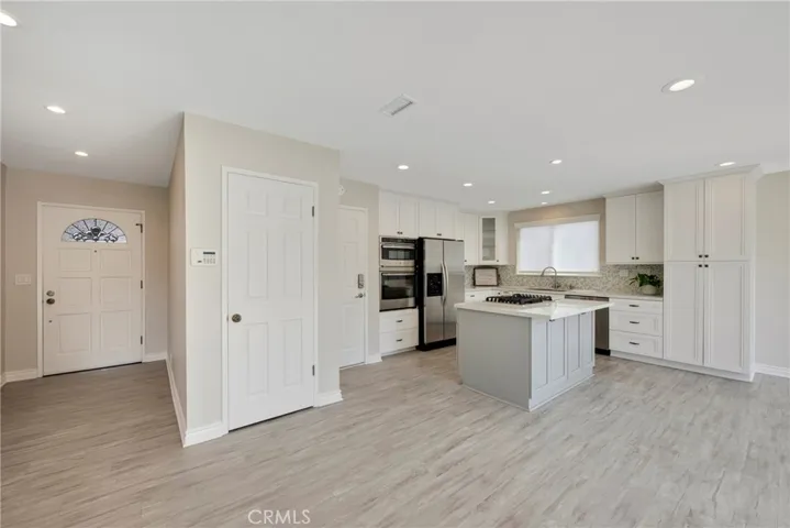 Kitchen with kitchen island ready for bar stools
