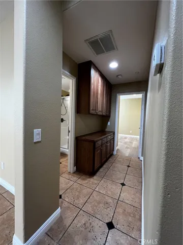 hallway to downstairs bathroom and bedroom 1