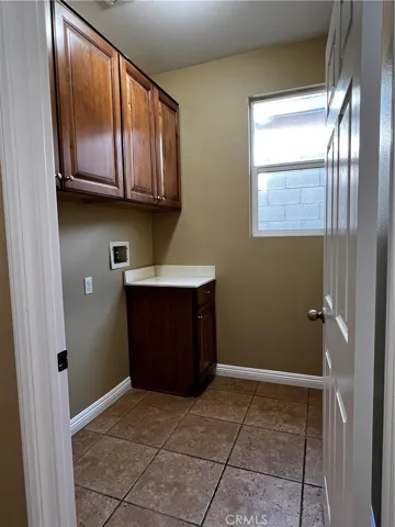 laundry room next to kitchen by garage door
