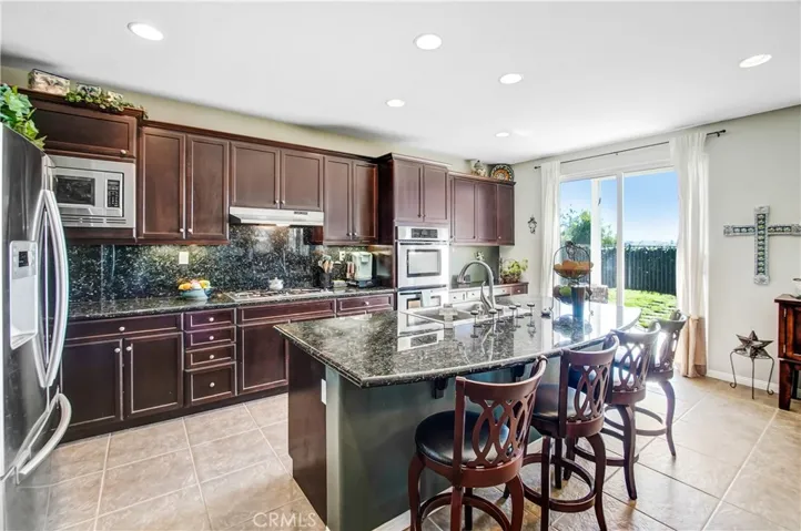 Large open kitchen with lots of cabinet space, granite countertops, stainless steel appliances with double ovens