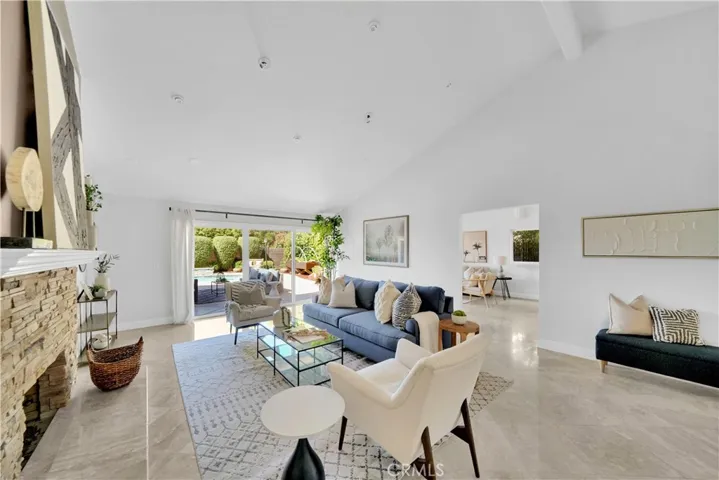 Living Room with cozy fireplace and volume ceiling