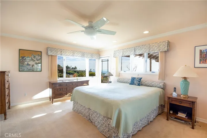Primary bedroom with door to outside near the in ground spa