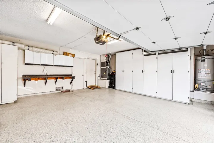 This a great garage: a workbench, plus lots of custom-made cabinets, and great lighting. There is also a nice epoxy flooring.