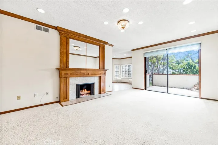 Beautiful fireplace mantle, canned lighting, also enjoy the sunshine and happiness of this Livingroom and dining room.
