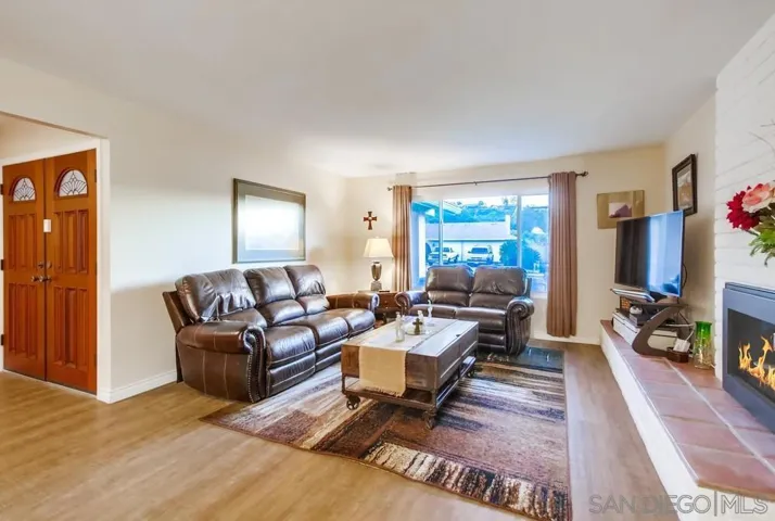 Big living room with oversized front window allowing for tons of natural light!