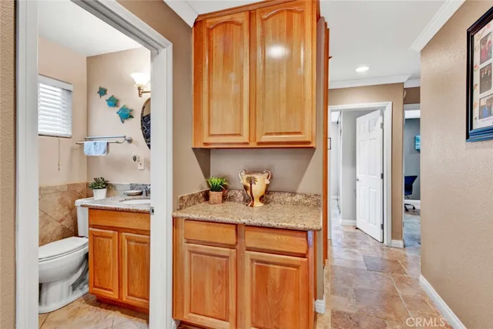 Spacious Hallway with Linen Closet and Granite Countertops