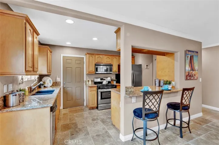 Kitchen Includes Granite Countertops, a Breakfast Bar, and Stainless Appliances
