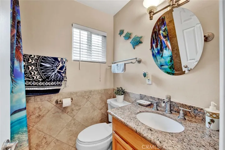 The Hall Bathroom has been Remodeled using Designer Tile Flooring, Wainscoting, and Surrounds