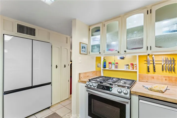 Kitchen with Samsung Bespoke appliances (light blue panels in storage)