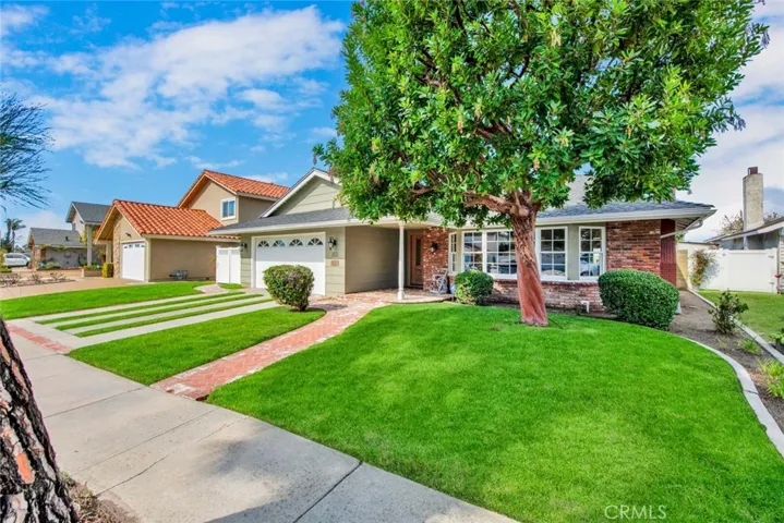 As you approach
this property you will be greeted by an enchanting brick ribbon driveway adorned with
lush grass accents complemented by charming brick walkways and raised planters. A
stunning Strawberry tree provides shade and beauty to the south facing front of the
property.