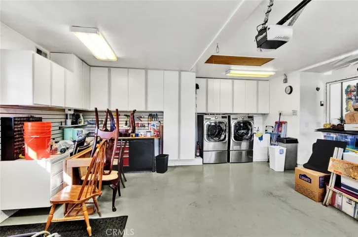 For the hobbyist or car enthusiast, the
custom finished garage is a true gem, featuring painted flooring, custom cabinets, a
workbench and a convenient pull down ladder which provides access to the fully
finished stand-up attic equipped with custom shelving for storage.