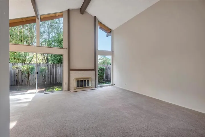 A wall of windows let the sun shine in.  A warm fireplace adds a feeling of hearth and home.