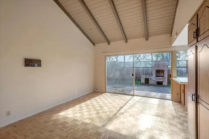 Wood beamed ceiling transforms this TV, game and entertainment area