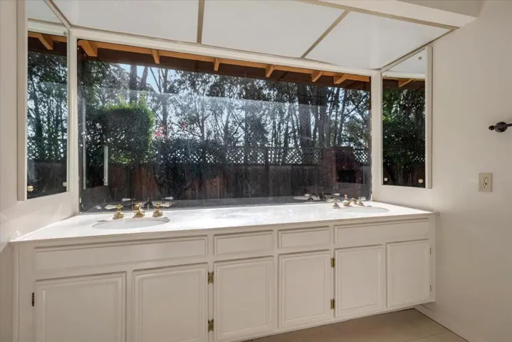 Night fall in the primary bedroom has its own bathroom with double sinks and vanity area