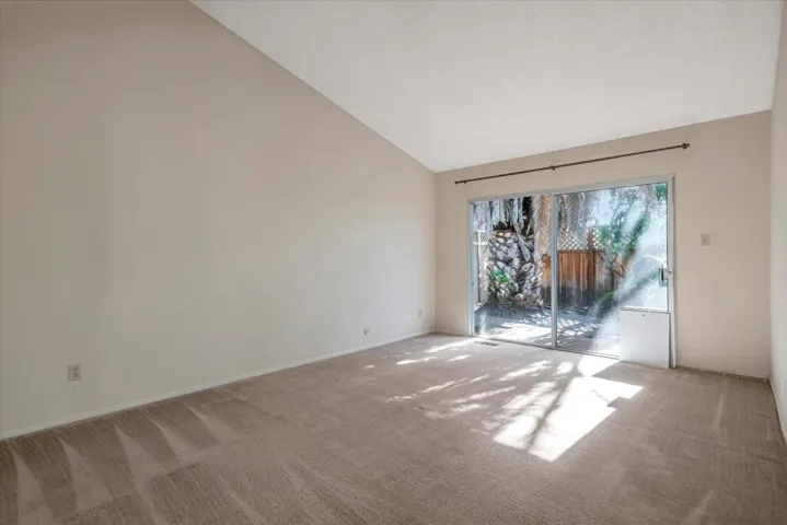 Primary bedroom patio door leads to expansive backyard