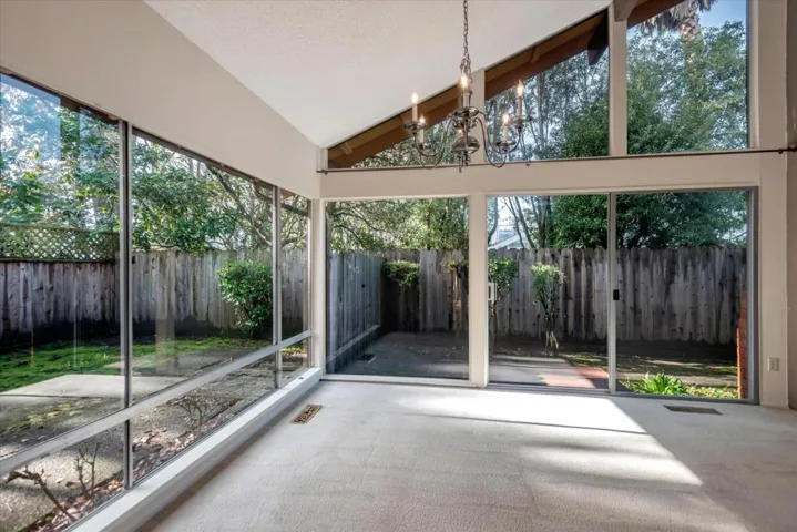 Open to the expansive backyard with a wall of windows bringing the outside in