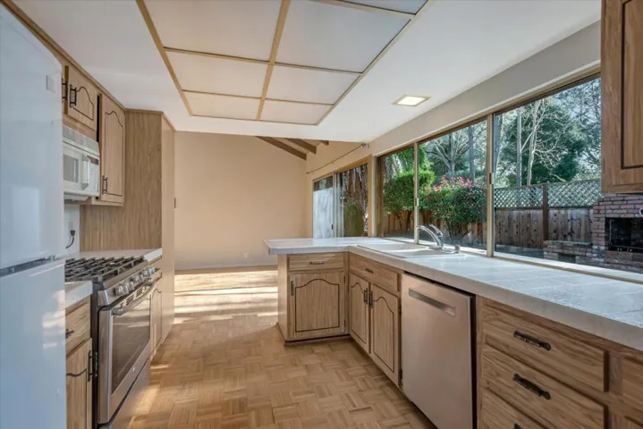 Lots of counter space in the bright kitchen overlooking the expansive backyard