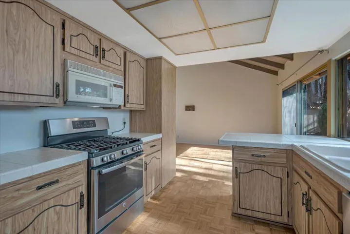 Gas stove, microwave, refrigerator, and dishwasher included.